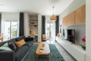 a living room with a couch and a tv at Kition City Apartments - Central Location in Larnaca