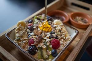 a tray of food with fruit and nuts on it at Corendon Amsterdam New-West, a Tribute Portfolio Hotel in Amsterdam