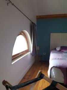 a room with a bed and a window in it at Loft avec SPA privatisé in Saint-Sulpice