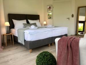 a bedroom with a large bed with two towels on it at RhönZeit Apartements und Zimmer in Hilders