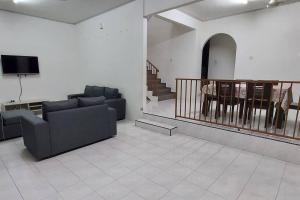 uma sala de estar com dois sofás e uma televisão em SDA Homestay Pool @StadiumDarulAman Untuk Muslim Sahaja em Alor Setar