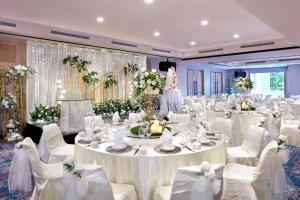a banquet hall with white tables and white chairs at Holiday Inn Express & Suites Singapore Novena by IHG in Singapore +48 photos