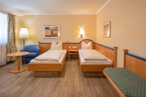 Postel nebo postele na pokoji v ubytování Hotel Neuwirt