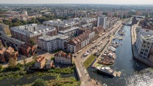 an aerial view of a city with a river and buildings at Apartamenty blisko Starego Miasta - Angielska Grobla by Renters in Gdańsk