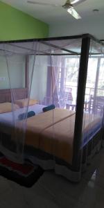 a bedroom with two beds with mosquito nets at Jagabay Resort & Surfing School in Weligama