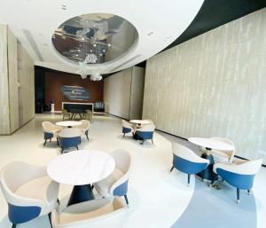 a lobby with tables and chairs and a piano at Platinum Coast Hotel and condominium 