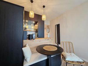 a room with a small table and a kitchen at Kaiserhof 311 mit Meerblick - Reinke in Norderney