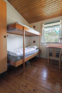 a bedroom with a bunk bed and a table at Magnificent house with splendid view to the sea in Fåborg