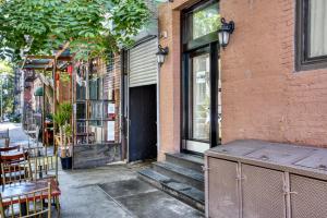 een bakstenen gebouw met een deur en een tafel en stoelen bij East Village 2br w wd nr groceries NYC-1221 in New York