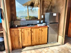 a kitchen with a refrigerator and a counter at Bela Flor Beach Front Apartments in Inhambane