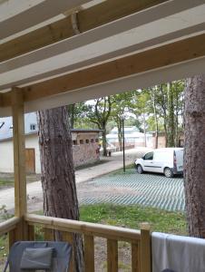 a view from a porch with a tree and a car at MOBIL HOME in Piriac-sur-Mer