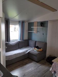 a living room with a couch and a window at MOBIL HOME in Piriac-sur-Mer