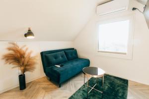 a living room with a green couch and a table at Domki Bliżej Chmur in Duszniki Zdrój