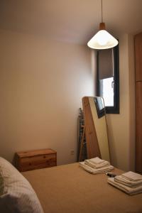 a bedroom with a bed and a mirror and a lamp at THE HOUSE ON THE ROCK in Antimácheia