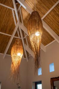 two lights hanging from the ceiling of a room at Bela Flor Beach Front Apartments in Inhambane