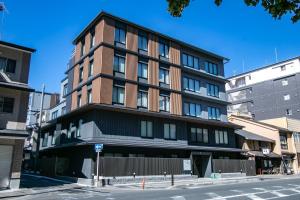 a tall building on the corner of a street at Minn Sanjo in Kyoto