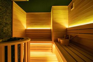 a sauna with a wooden floor and a tub at Minn Sanjo in Kyoto