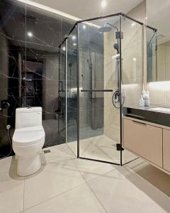 a bathroom with a toilet and a glass shower at I-VISTA HOTEL in Tawau +16 photos