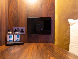 a hotel room with a counter with a bottle of water at Bloc Hotel London Gatwick Airport in Horley