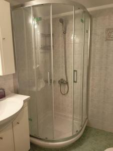 a shower with a glass door in a bathroom at Pnoe Luxury House in Nafplio +9 photos