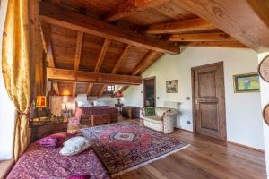 a bedroom with a bed and a wooden ceiling at L'Atelier du Temps - LE SECRET in Aosta