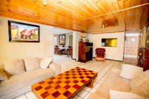 a living room with a couch and a checkerboard table at Oria Lodge in Cape Town