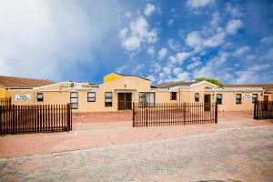 a building with a fence in front of it at Oria Lodge in Cape Town