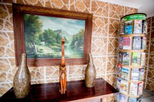 two vases sitting on a table next to a painting at Oria Lodge in Cape Town