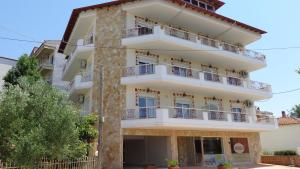 a building with balconies on the side of it at Mouses-X in Nea Kallikrateia