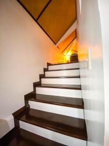 a staircase in a house with black and white at Kavanah Suites Guinhawa Tagaytay in Tagaytay