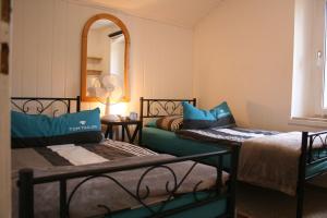 a room with two beds and a mirror at Your Work & Stay Home in Mechernich in Mechernich
