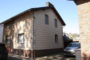 a house with a car parked in front of it at Your Work & Stay Home in Mechernich in Mechernich