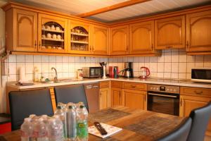 a kitchen with wooden cabinets and a wooden table at Your Work & Stay Home in Mechernich in Mechernich