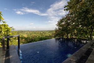 a plunge pool with a view of a tree at The Paz Khao Yai in Nong Sarai