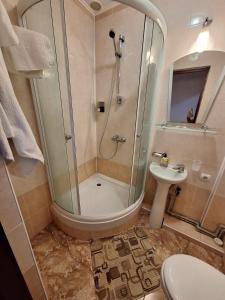 a bathroom with a shower and a sink at Барселона in Odesa