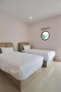 Postel nebo postele na pokoji v ubytování Chanmuang Resort ชานเมืองรีสอร์ท