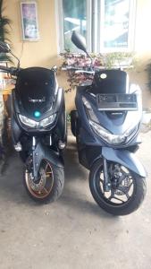 a motor scooter parked in front of a house at D-Rima Homestay Ruteng in Ruteng