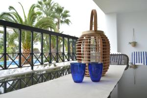 three blue vases sitting on a table on a balcony at Casa Sol Calahonda in Sitio de Calahonda