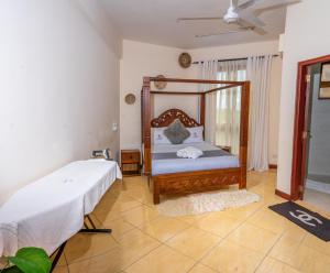 a bedroom with a bed in a room at ZaNaKri Homes ;A Great Panorama of Indian Ocean in Mombasa