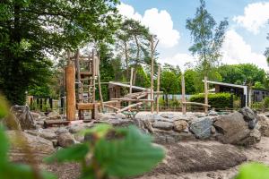 a playground in a park with a wooden play structure at TopParken - Resort Veluwe in Garderen