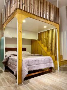 a bedroom with a large bed and a staircase at JORA LOFT - Japandi inspired apt 1- D in Dagupan