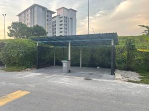 a parking lot with a trash can in front of a building at 3Bedroom Full AirCond House with Pool@PortDickson in Port Dickson