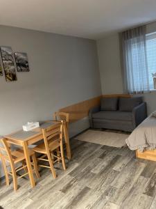 a living room with a table and chairs and a couch at Apartmány Andělská in Olomouc