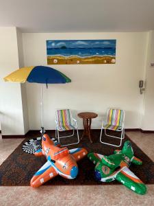 a room with two inflatable planes and a table and chairs at Kata Place Hotel in Kata Beach