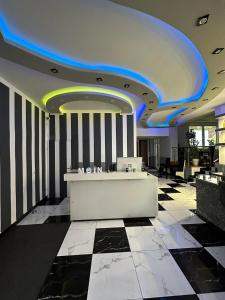 a lobby with a reception desk and a blue ceiling at Hotel Deutscher Hof in Schleswig