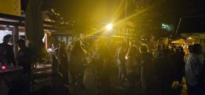 a crowd of people standing on a street at night at Hotel S Family Jovicevic in Rijeka Crnojevića