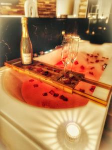 a bottle of champagne and two glasses on a counter at Damelys in Gourdinne +5 photos