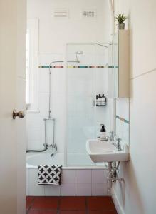 a bathroom with a shower and a sink at Sunny Side Up - Beachside Living on Marine Parade in Melbourne