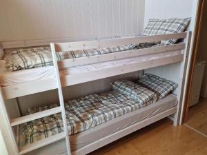 two bunk beds in a small room with at Tobiasbua in Svolvær