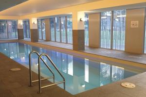 a swimming pool in a building with a pool at Stunning Modern Style with a Gym, Pool and Spa in Melbourne